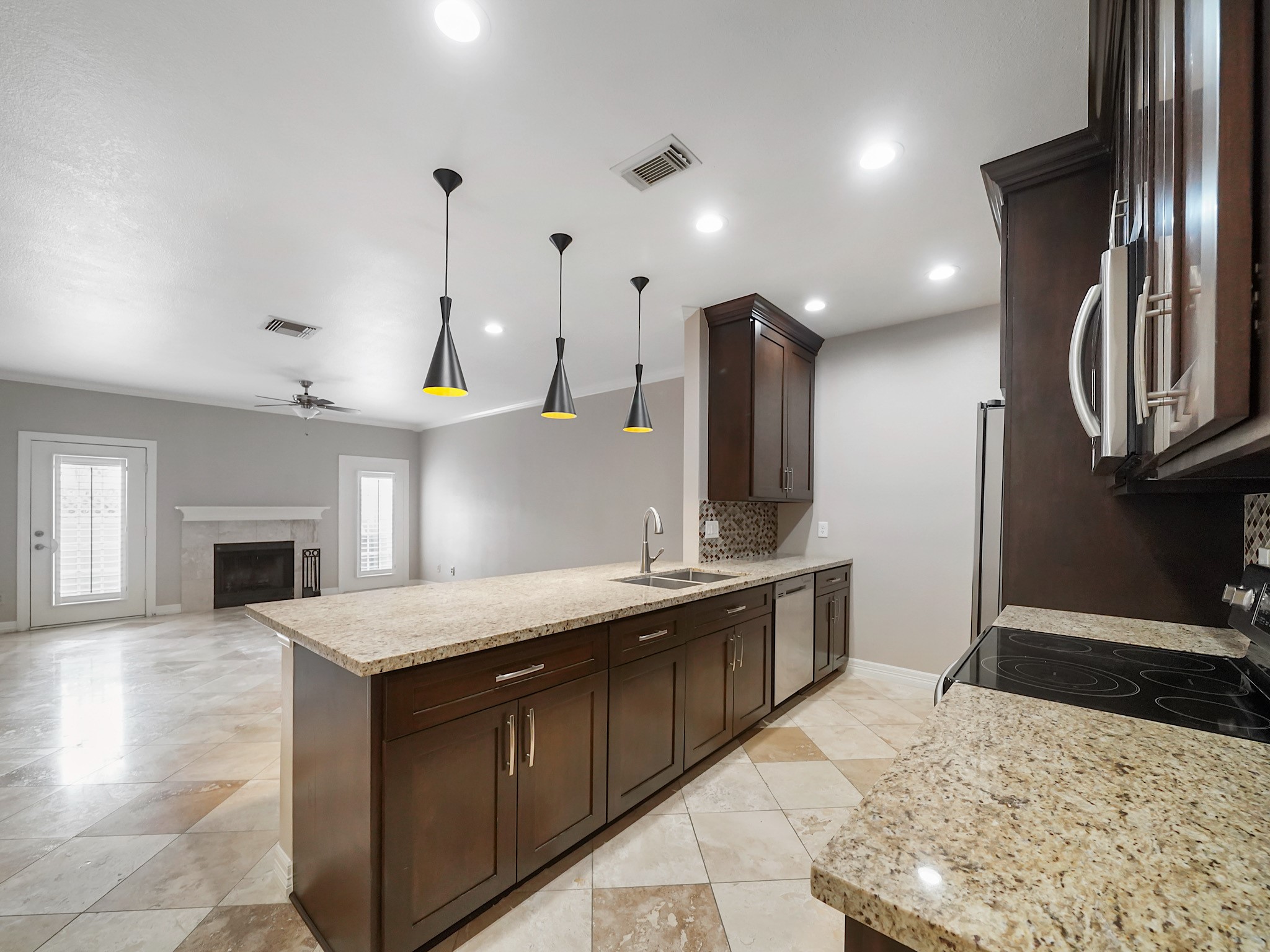 6000 Reims Road, Unit 2205 Houston, TX 77036 - Photo 35 of 35 Open floor plan with clear sight lines from kitchen to living area and entry.