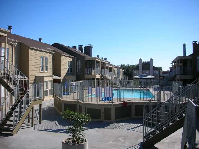 2529 Rio Grande Street, Unit 102 Austin, TX 78705 - Photo 3 of 7 a balcony with table and chairs