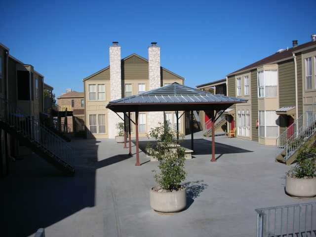 2529 Rio Grande Street, Unit 102 Austin, TX 78705 - Photo 4 of 7 a view of a patio with chairs and potted plants
