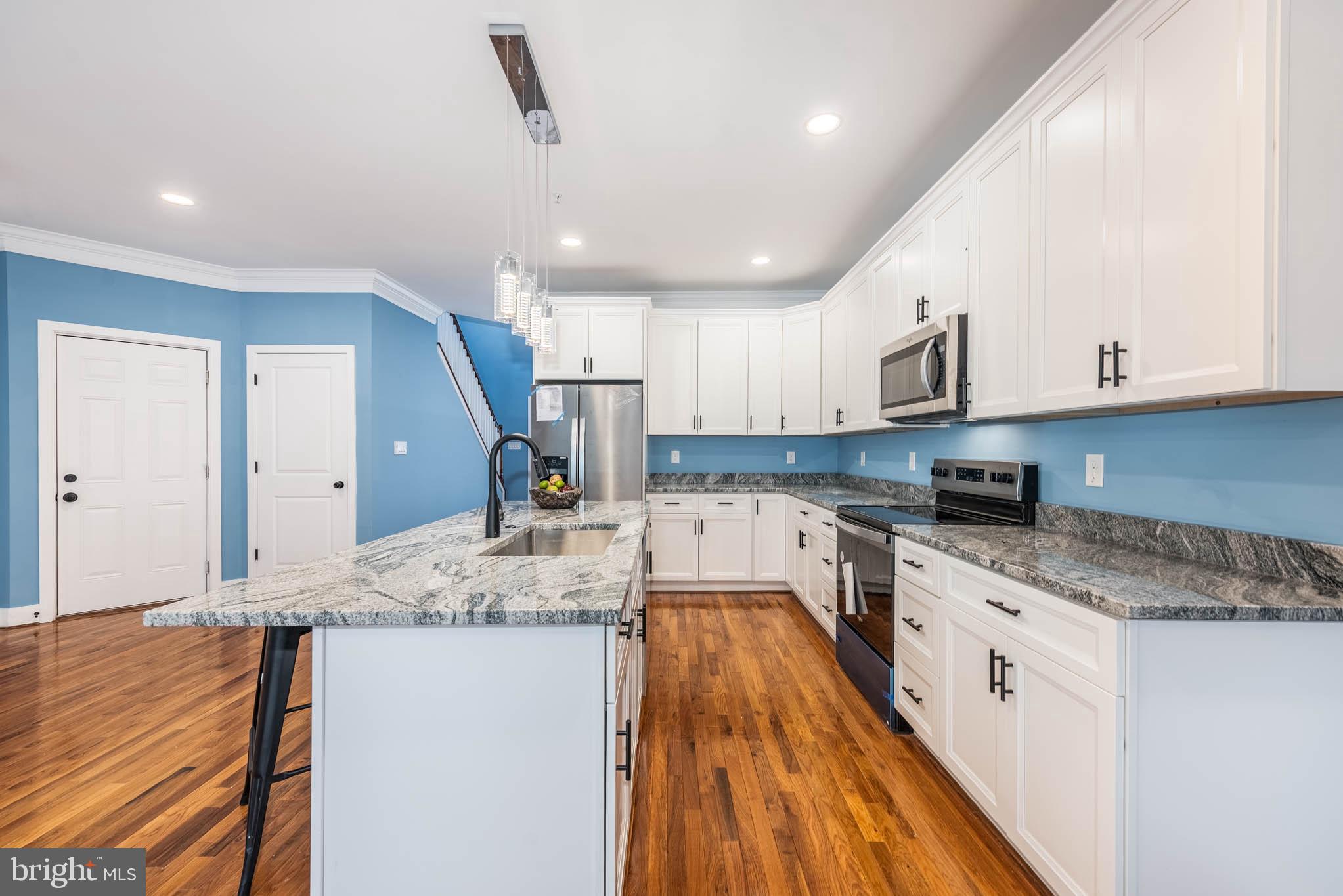8307 Bletzer Road Baltimore, MD 21222 - Photo 12 of 37 a kitchen with a sink stove and cabinets