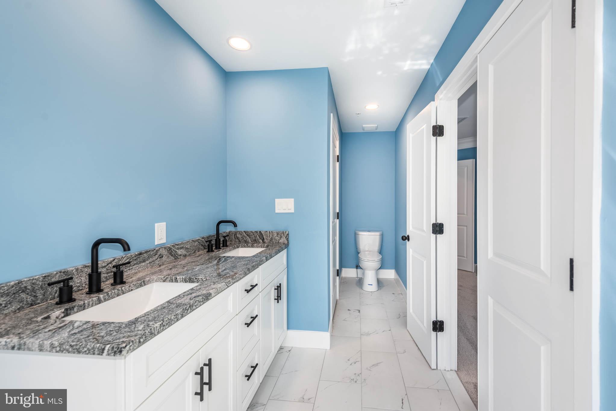 8307 Bletzer Road Baltimore, MD 21222 - Photo 20 of 37 a bathroom with a granite countertop sink and a mirror