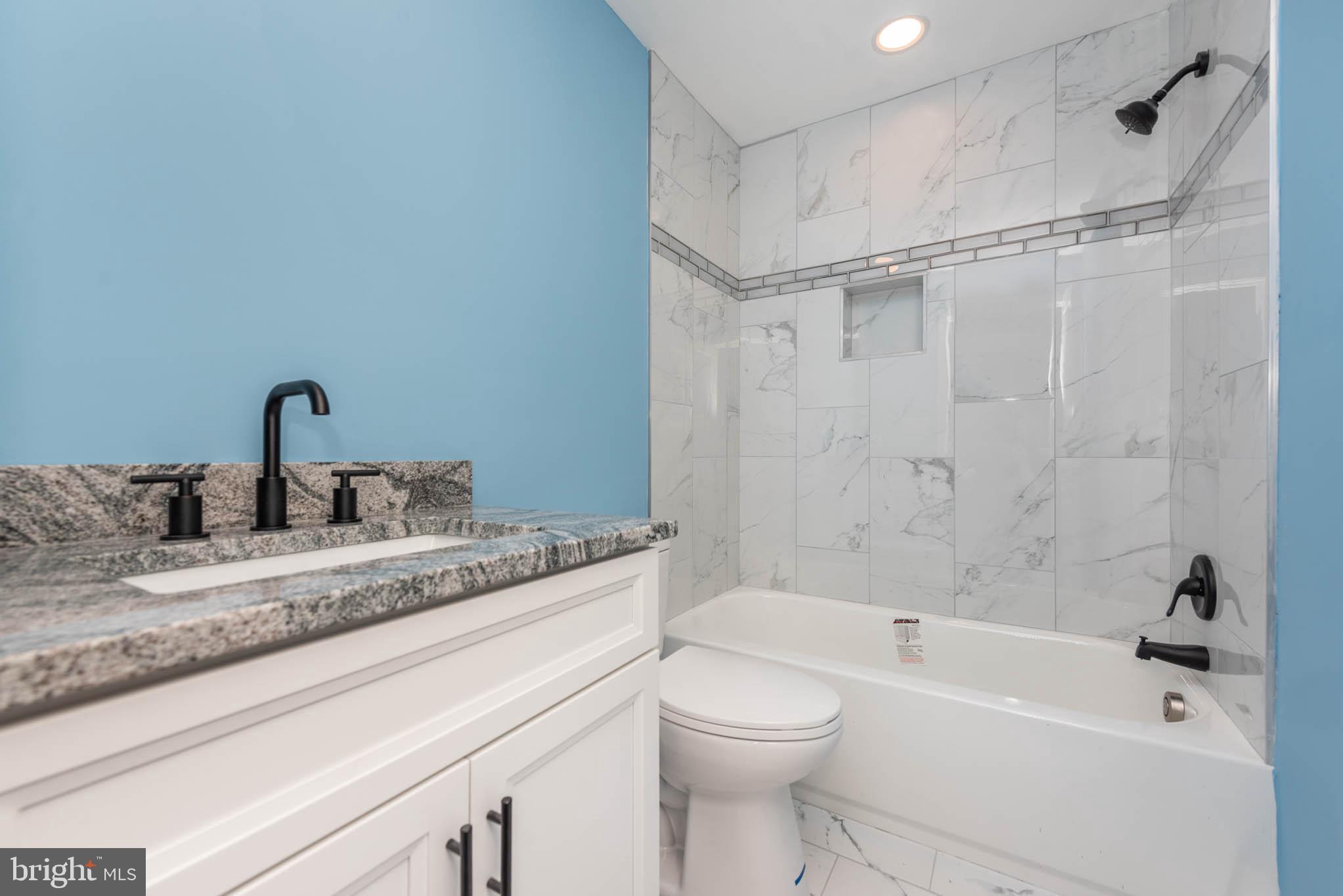 8307 Bletzer Road Baltimore, MD 21222 - Photo 23 of 37 a bathroom with a granite countertop sink toilet and shower