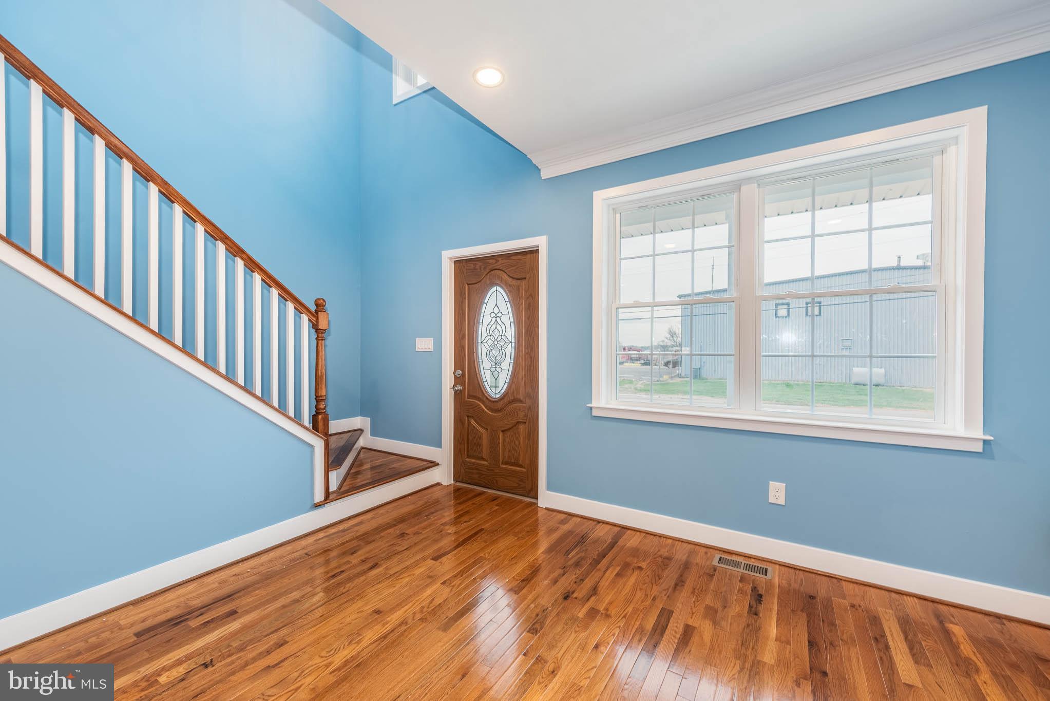 8307 Bletzer Road Baltimore, MD 21222 - Photo 3 of 37 a view of an empty room with wooden floor and a window