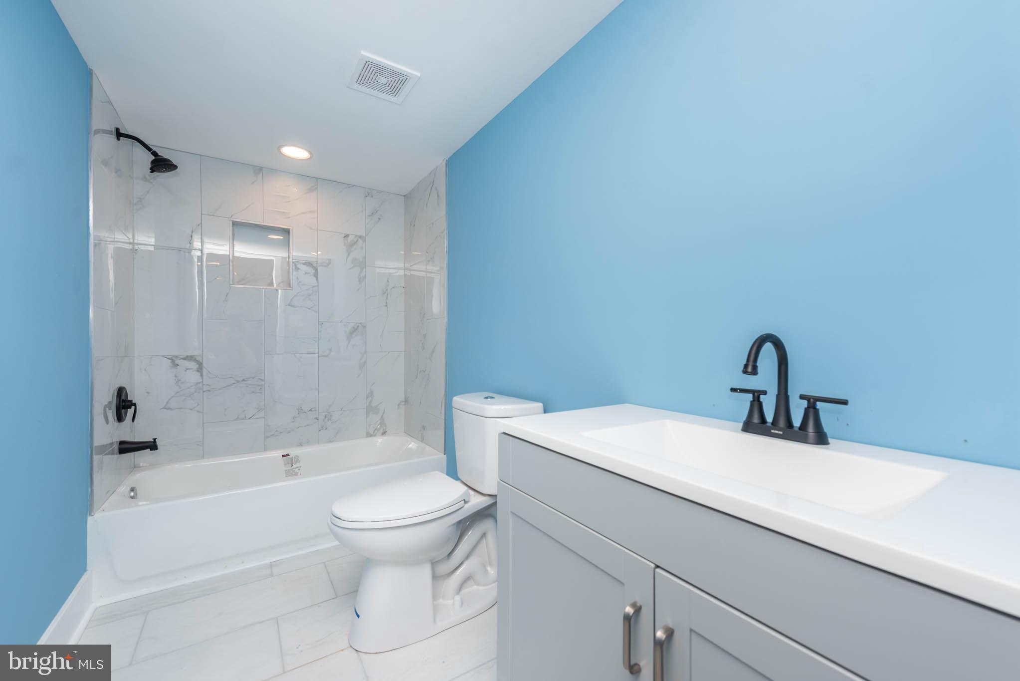 8307 Bletzer Road Baltimore, MD 21222 - Photo 33 of 37 a bathroom with a bathtub shower sink mirror vanity and toilet