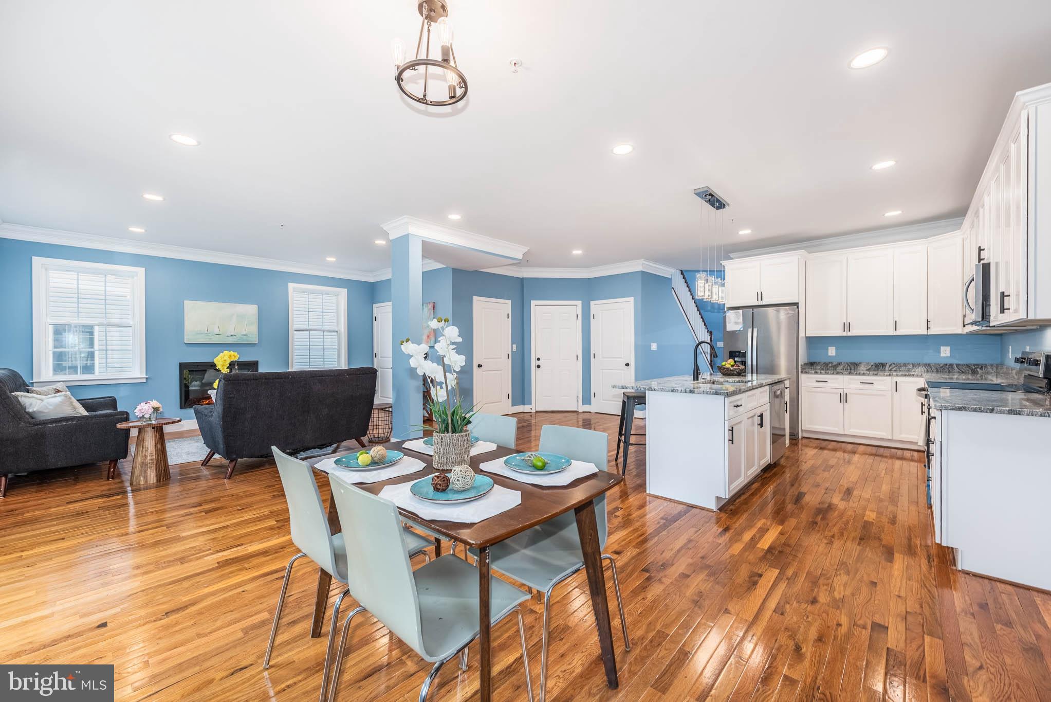 8307 Bletzer Road Baltimore, MD 21222 - Photo 4 of 37 a open dining room with stainless steel appliances kitchen island granite countertop a dining table chairs and kitchen view