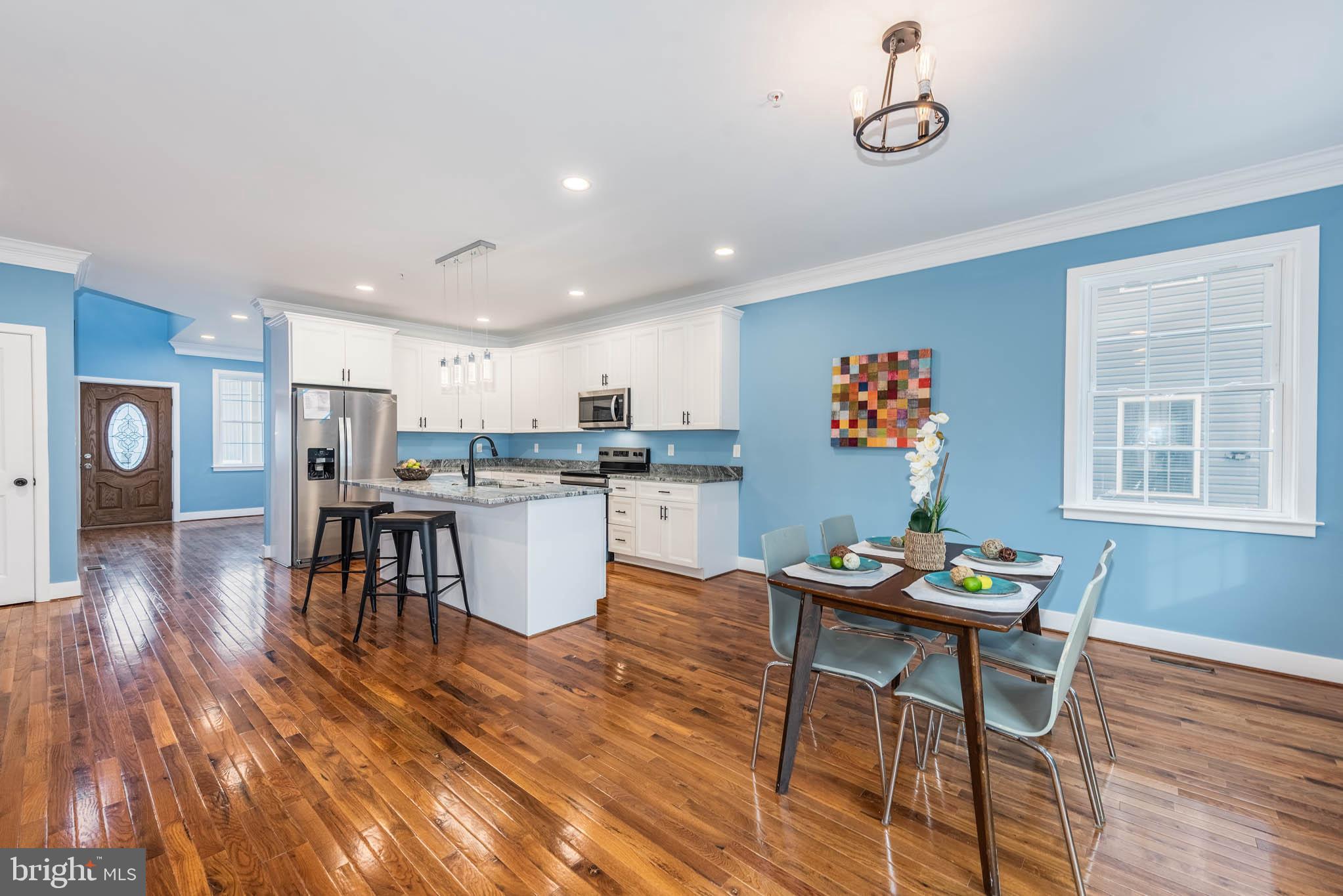 8307 Bletzer Road Baltimore, MD 21222 - Photo 8 of 37 a living room with dining table and wooden floor