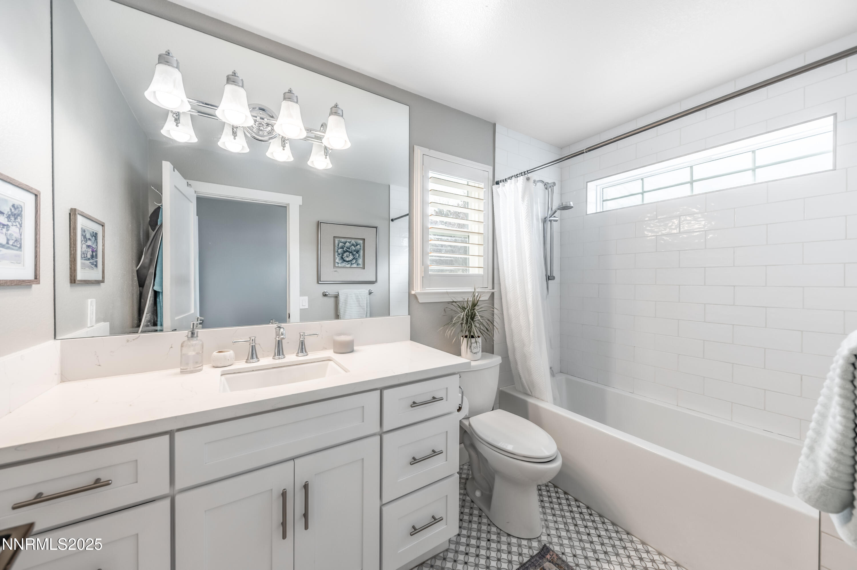 30 Calla Lily Court Reno, NV 89511 - Photo 20 of 34 a bathroom with a sink a toilet and a large mirror