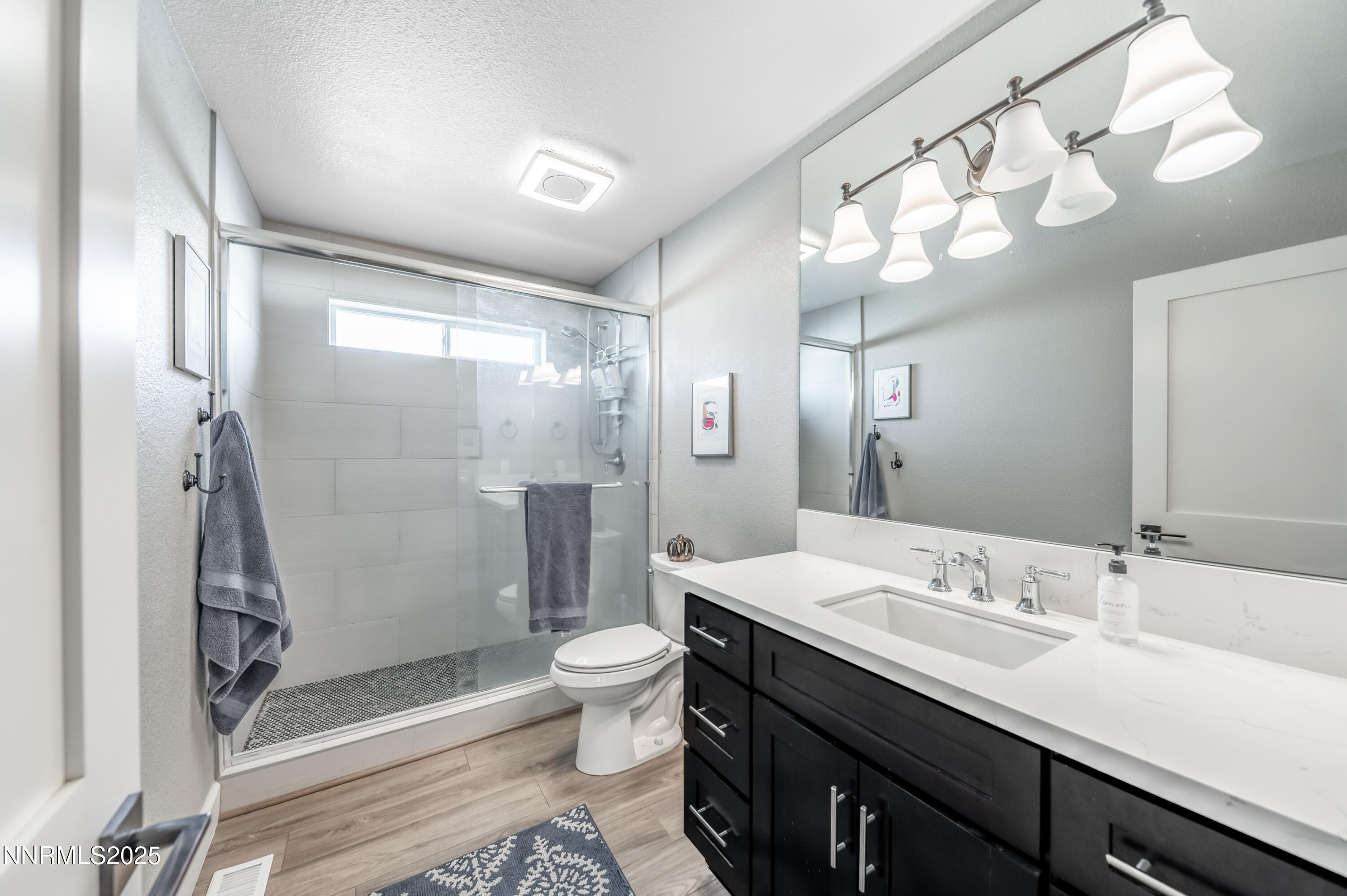 30 Calla Lily Court Reno, NV 89511 - Photo 23 of 34 a bathroom with a double vanity sink mirror toilet and shower