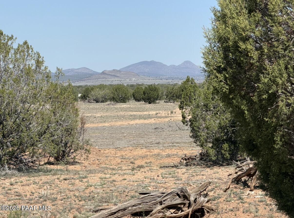 a view of dirt road with a building in the background