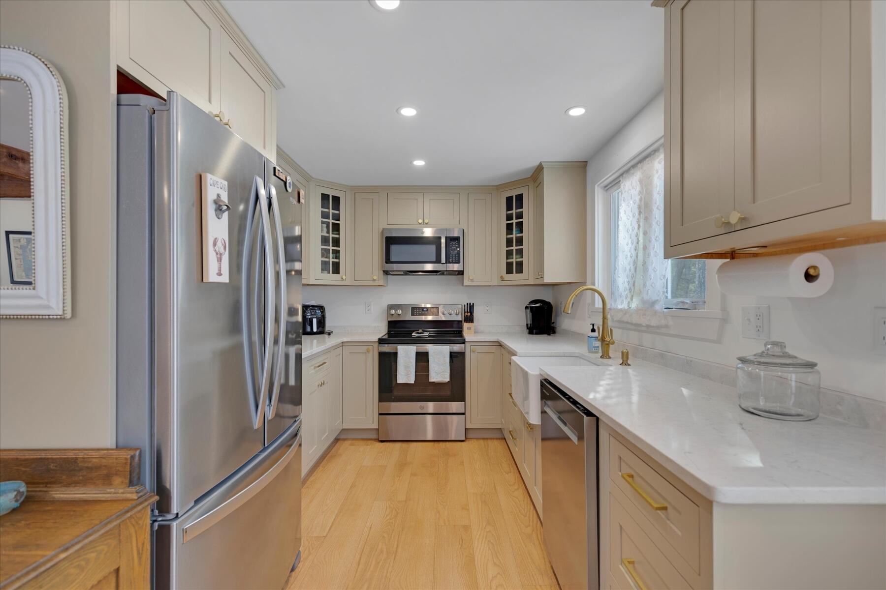 82 Old Fields Road Sandwich, MA 02563 - Photo 11 of 34 a kitchen with stainless steel appliances a refrigerator sink and cabinets