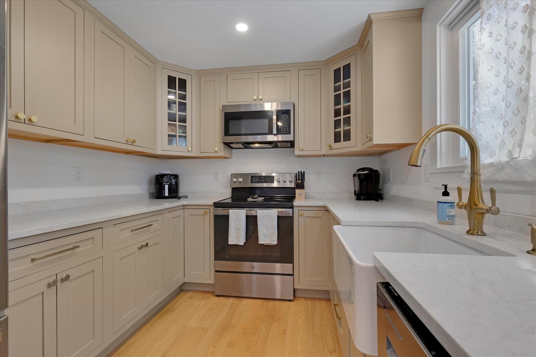 82 Old Fields Road Sandwich, MA 02563 - Photo 12 of 34 a kitchen with stainless steel appliances granite countertop a sink and white cabinets