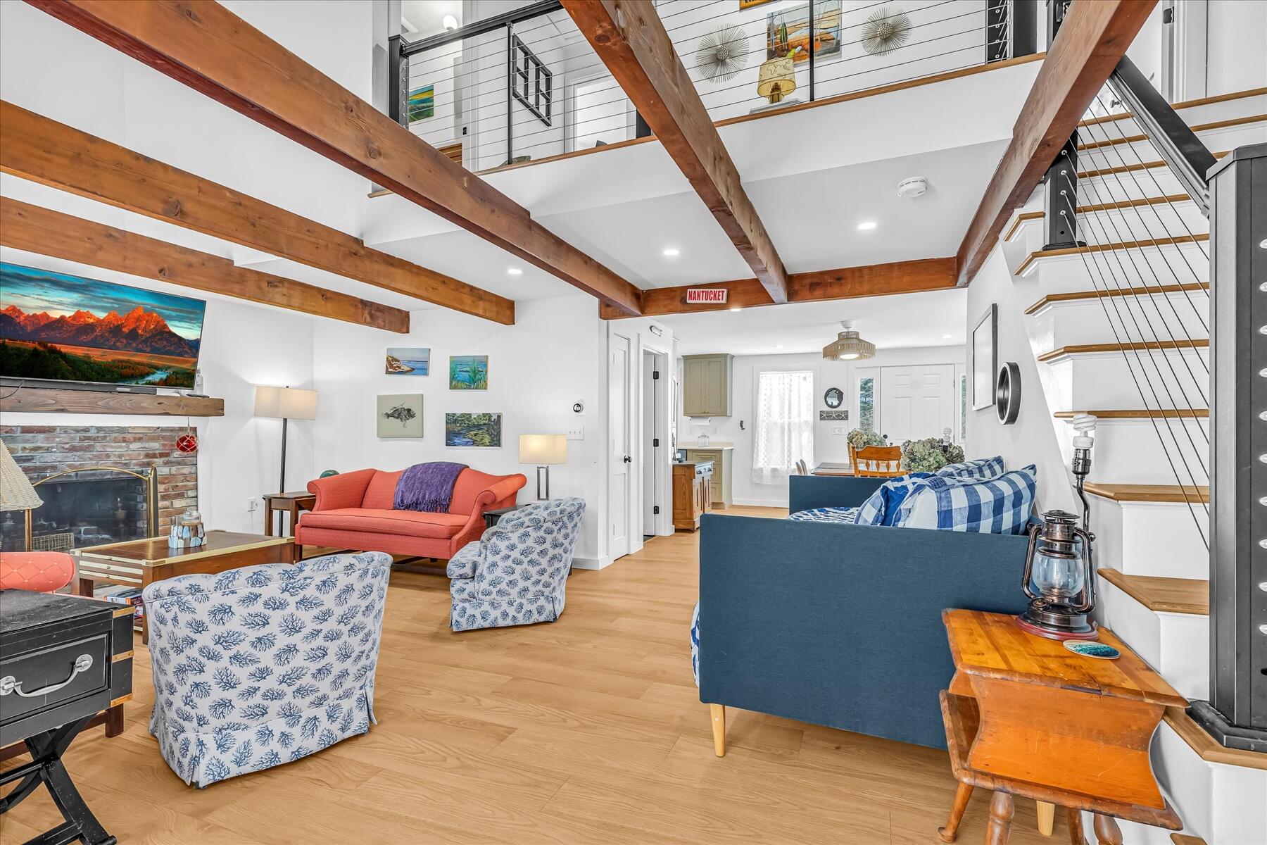 82 Old Fields Road Sandwich, MA 02563 - Photo 18 of 34 a living room with furniture a fireplace and a floor to ceiling window