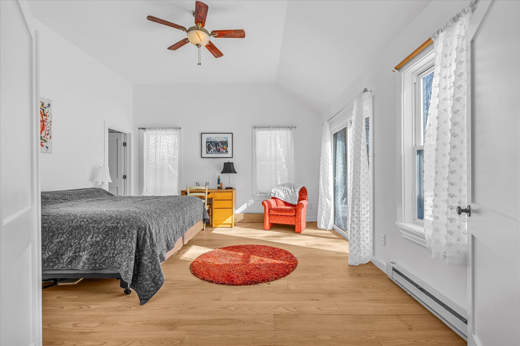 82 Old Fields Road Sandwich, MA 02563 - Photo 20 of 34 a bedroom with a bed and a chandelier