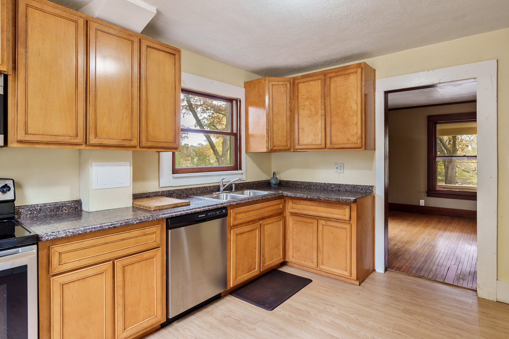 708 South Bluff Road South Beloit, IL 61080 - Photo 16 of 32 a kitchen with stainless steel appliances granite countertop wooden cabinets a sink and dishwasher with wooden floor