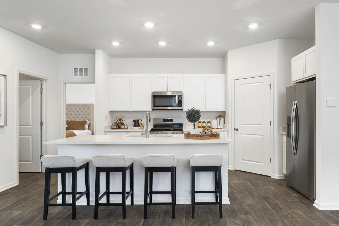 6412 Stony Brook Lane Wonder Lake, IL 60097 - Photo 12 of 36 a kitchen with stainless steel appliances a dining table chairs microwave and refrigerator
