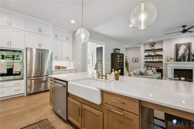 a kitchen with kitchen island a counter space cabinets and stainless steel appliances