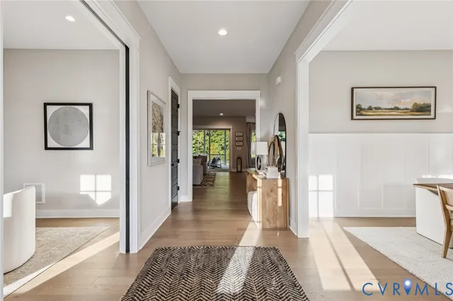 a hallway with beautiful frames and painting on the wall