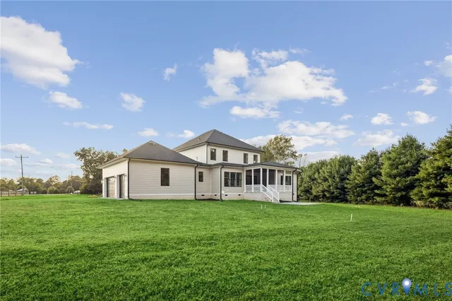 a front view of a house with garden and trees