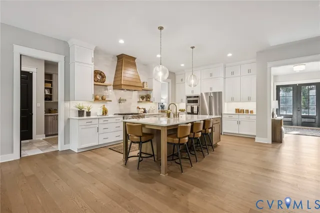 a large kitchen with a table and chairs