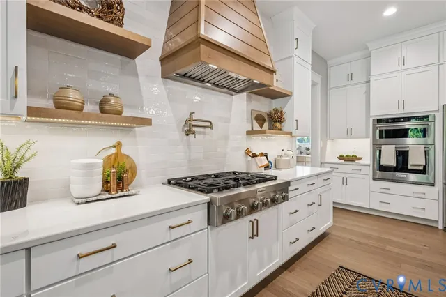 a kitchen with stainless steel appliances granite countertop a sink and a stove