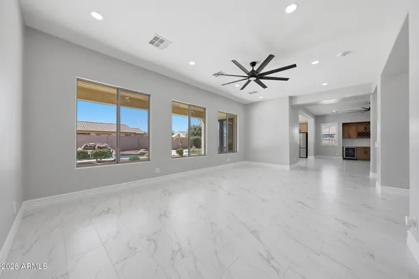 a large kitchen with stainless steel appliances kitchen island granite countertop a refrigerator and a sink