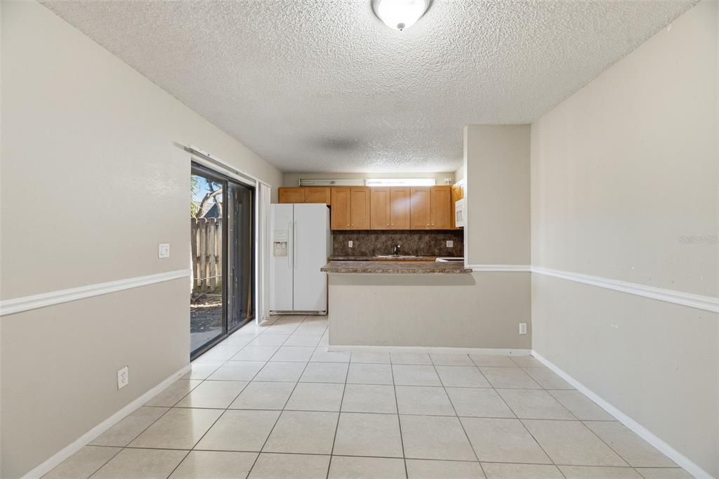 238 Woodland Road Palm Springs, FL 33461 - Photo 12 of 33 a view of a kitchen with a sink and a refrigerator