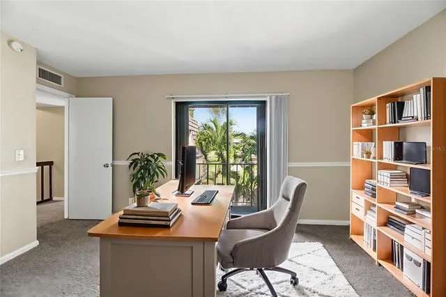 a bedroom with a large bed and a flat tv screen