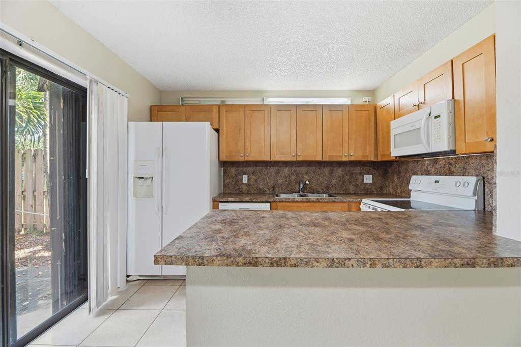 238 Woodland Road Palm Springs, FL 33461 - Photo 8 of 33 a view of a kitchen with granite countertop cabinets
