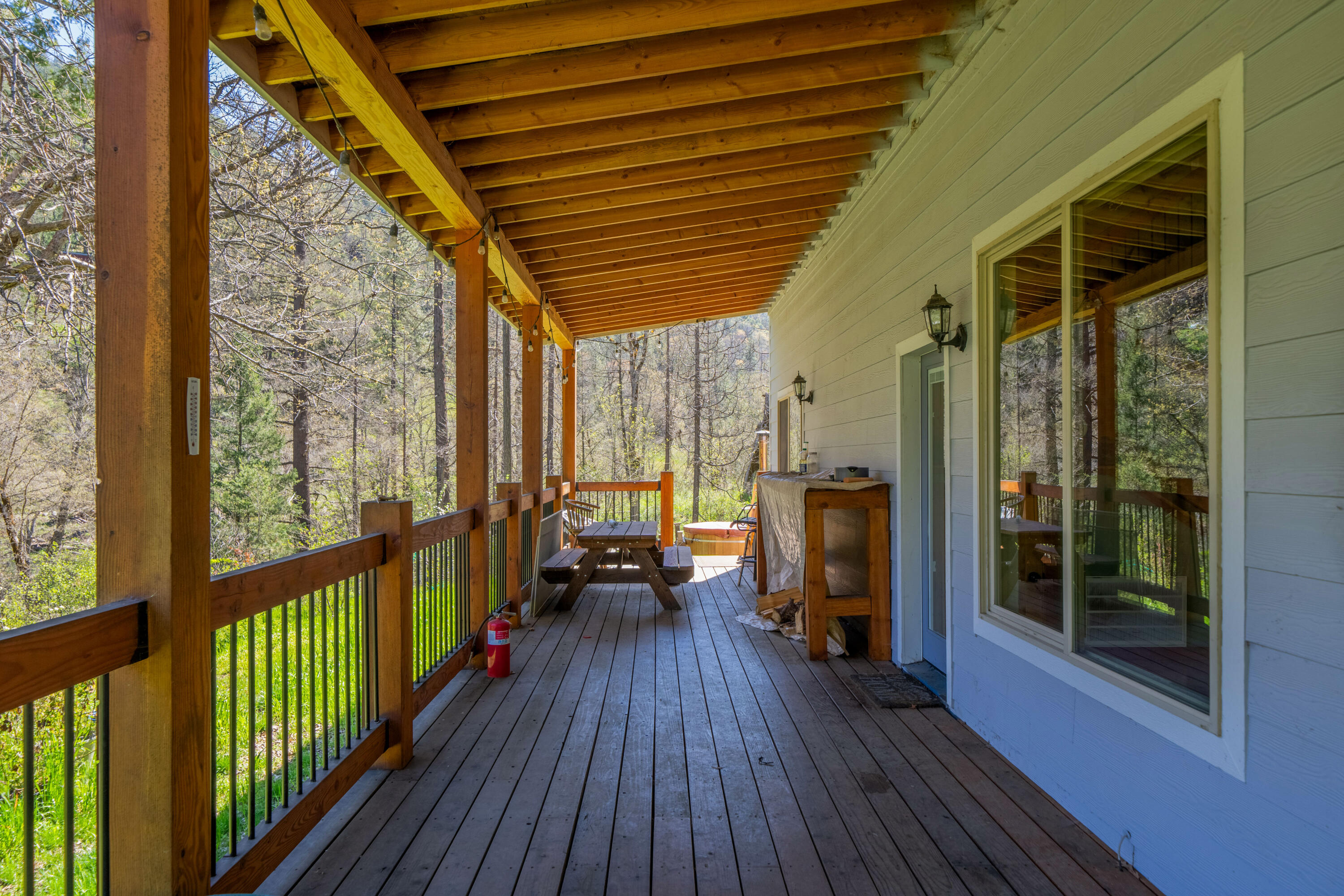 8916 Reading Creek Road Douglas City, CA 96024 - Photo 22 of 48 a view of a porch with wooden floor and outdoor seating