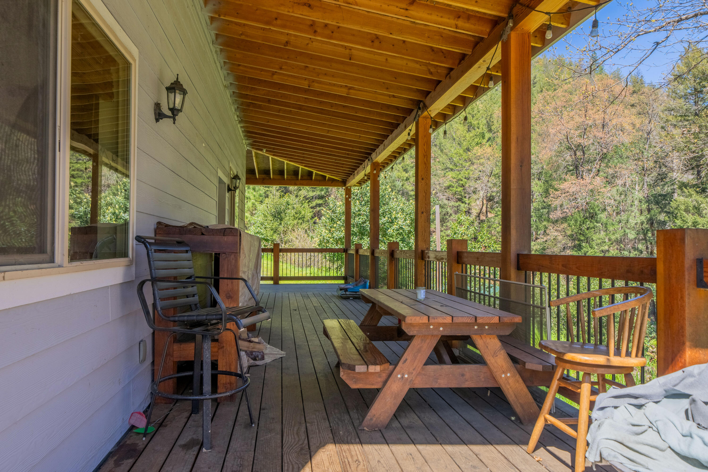 8916 Reading Creek Road Douglas City, CA 96024 - Photo 26 of 48 a view of a patio with wooden floor chairs and a table