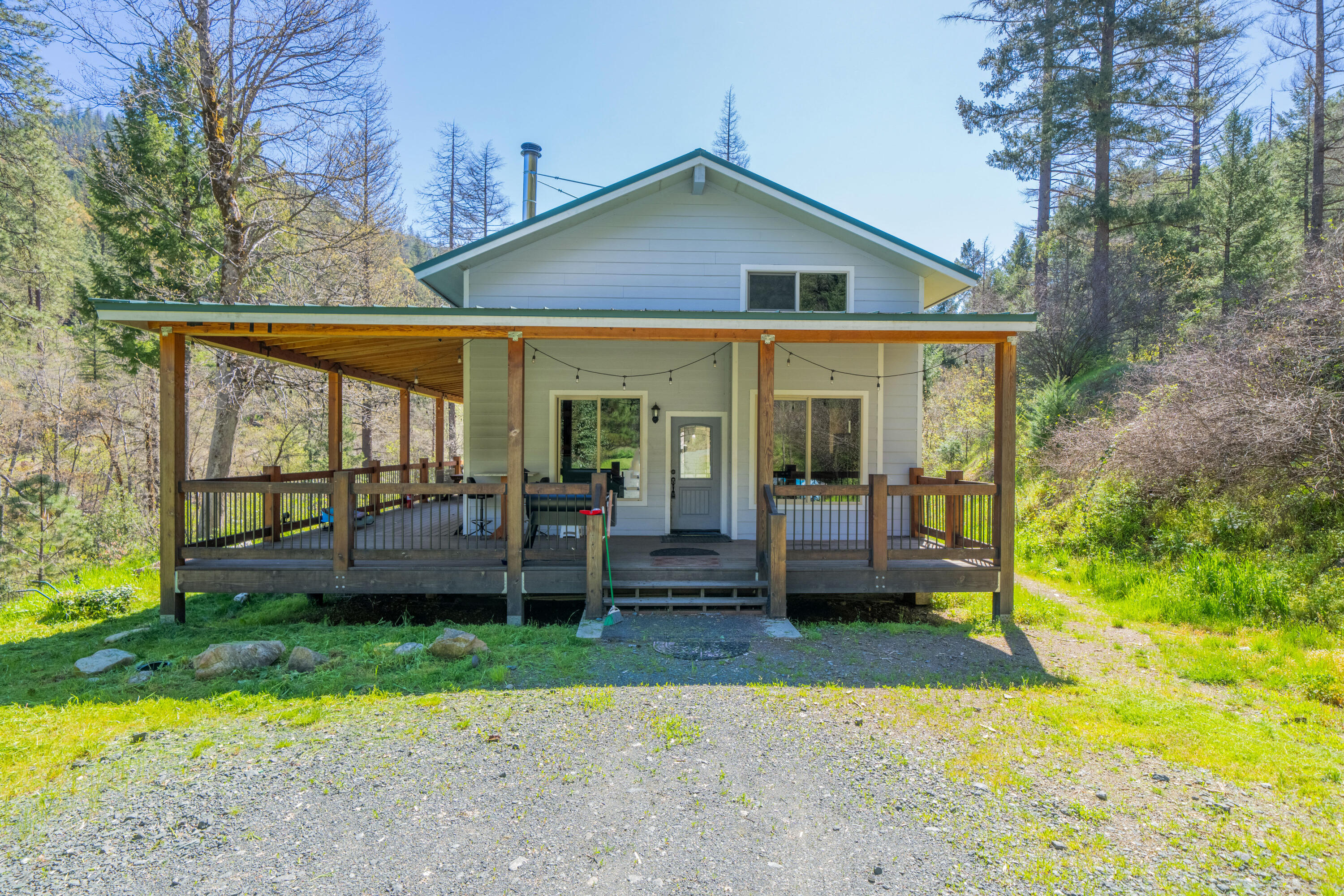 8916 Reading Creek Road Douglas City, CA 96024 - Photo 3 of 48 a front view of a house with a yard table and chairs