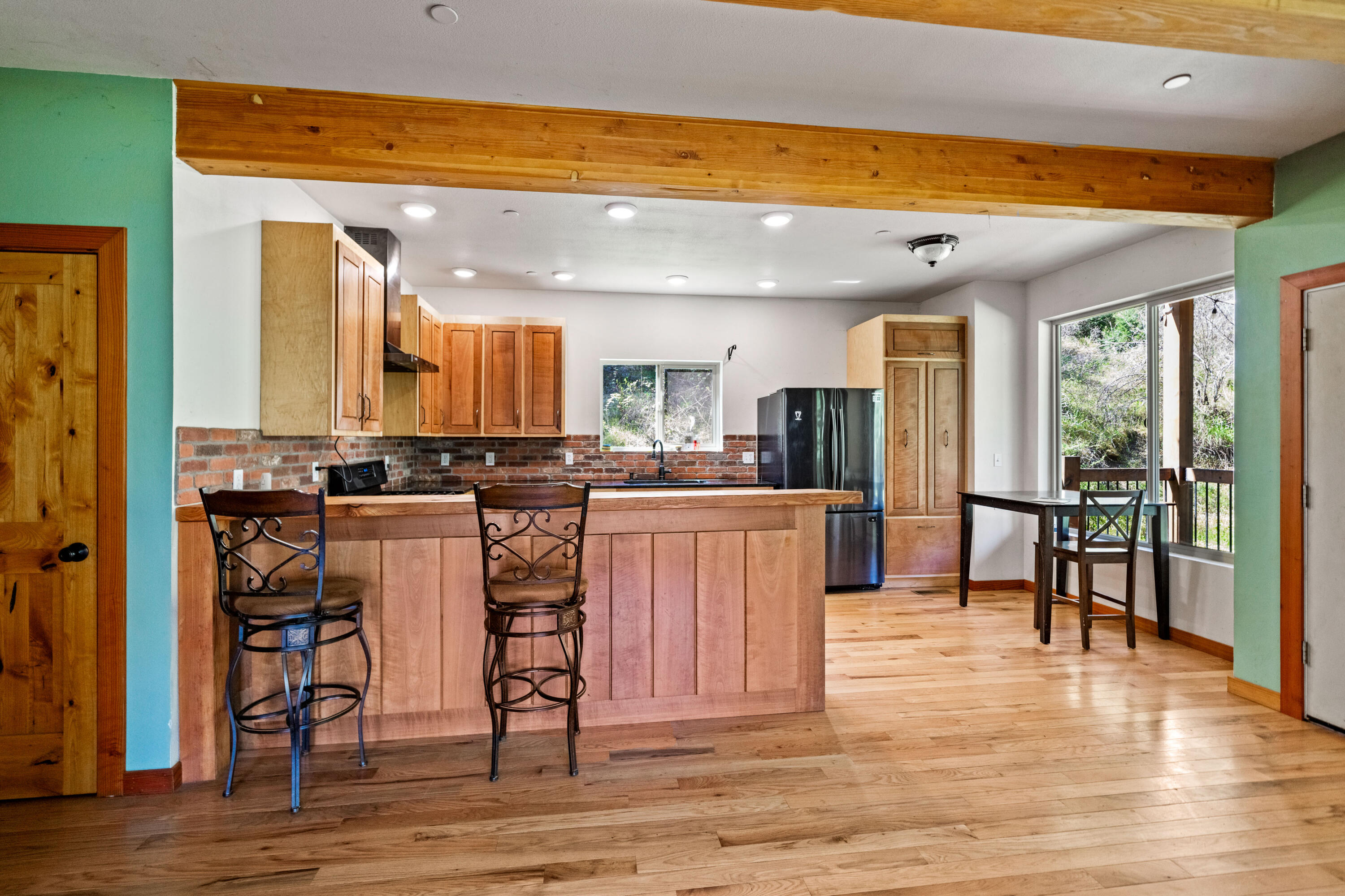 8916 Reading Creek Road Douglas City, CA 96024 - Photo 6 of 48 a kitchen with stainless steel appliances kitchen island granite countertop a table chairs and a refrigerator