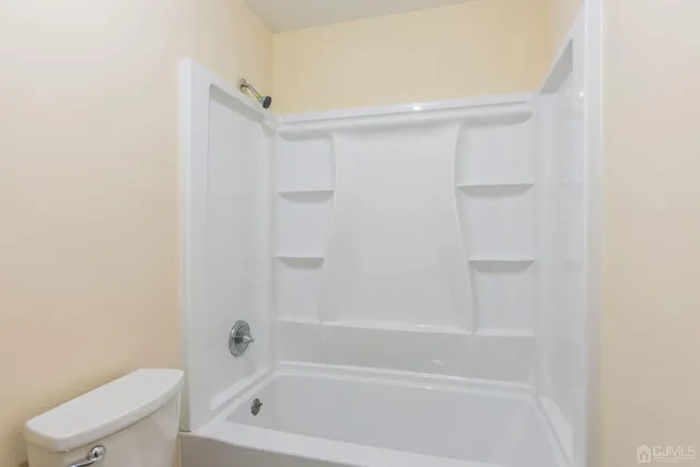 a bathroom with a bathtub and toilet