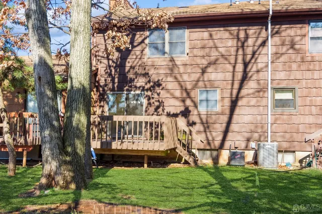 a view of yard with large trees and wooden fence