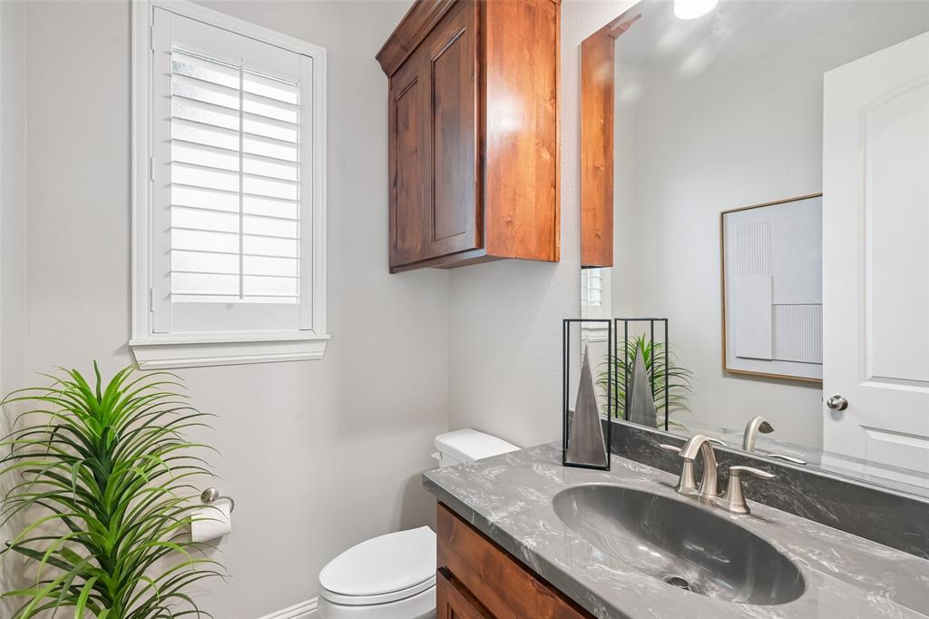 1657 Florence Road Keller, TX 76262 - Photo 8 of 40 a bathroom with a granite countertop sink a toilet and a mirror