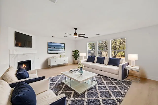 a living room with furniture a fireplace and a flat screen tv