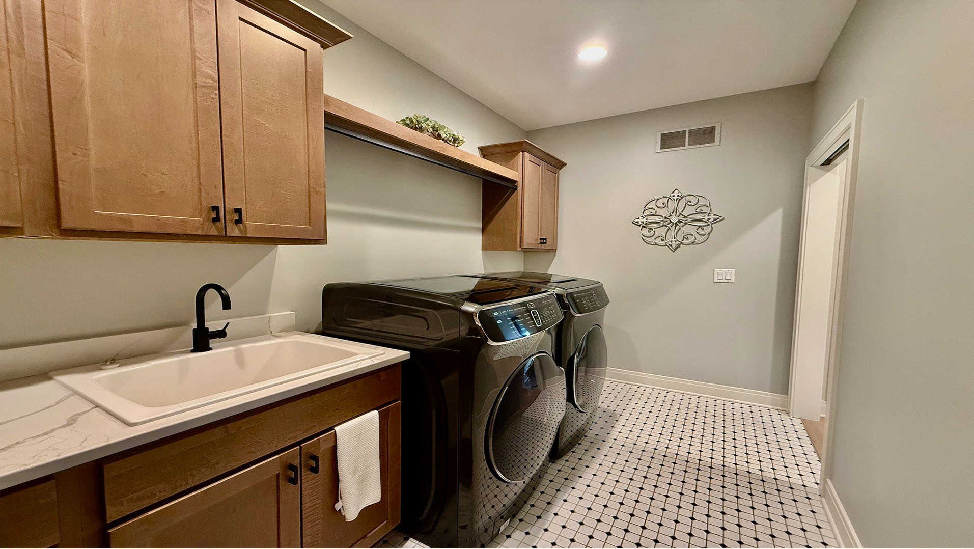 5077 Oak Rdg Court Bettendorf, IA 52722 - Photo 13 of 35 a utility room with sink dryer and washer