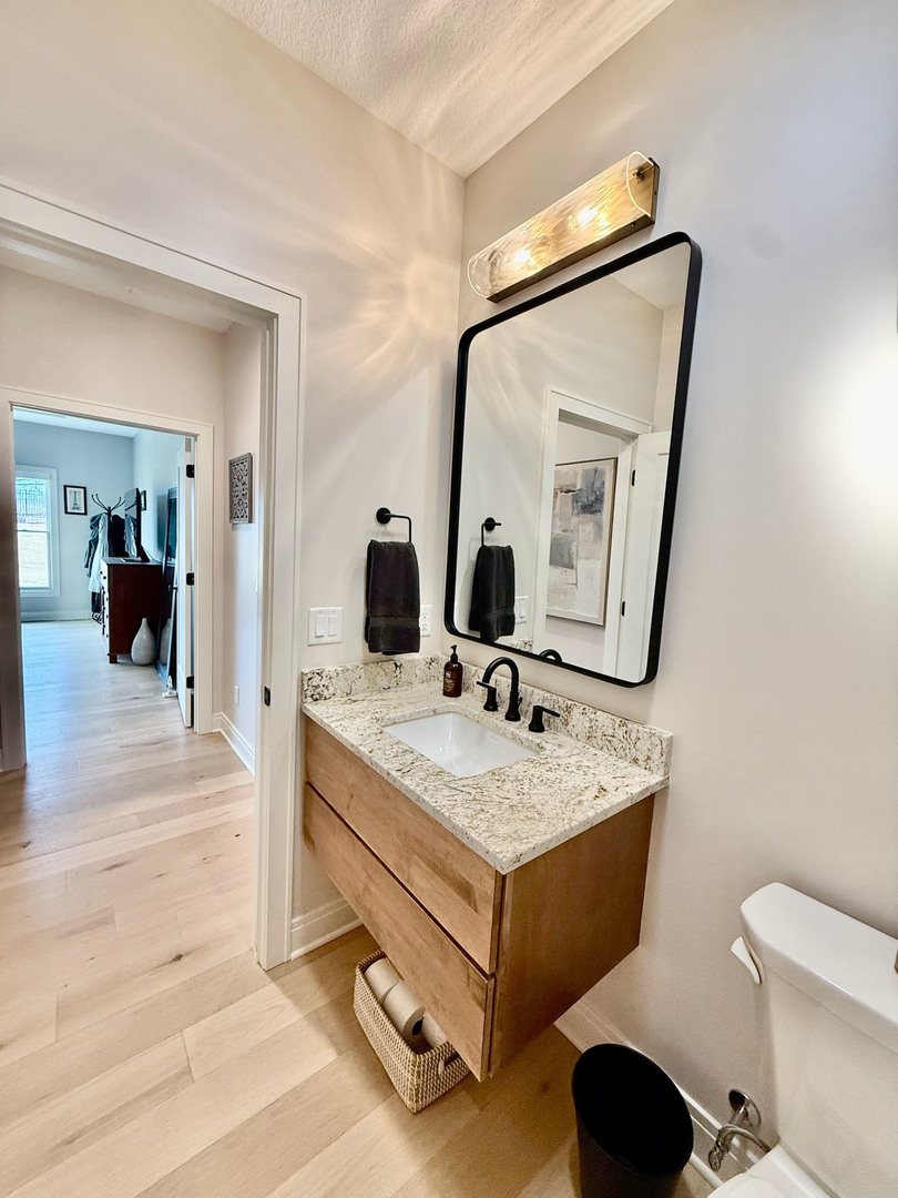 5077 Oak Rdg Court Bettendorf, IA 52722 - Photo 18 of 35 a en suite bathroom with a granite countertop sink and a mirror