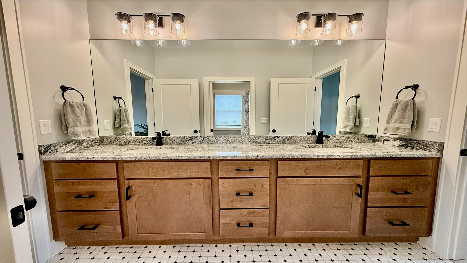 5077 Oak Rdg Court Bettendorf, IA 52722 - Photo 22 of 35 a bathroom with a sink vanity and mirror