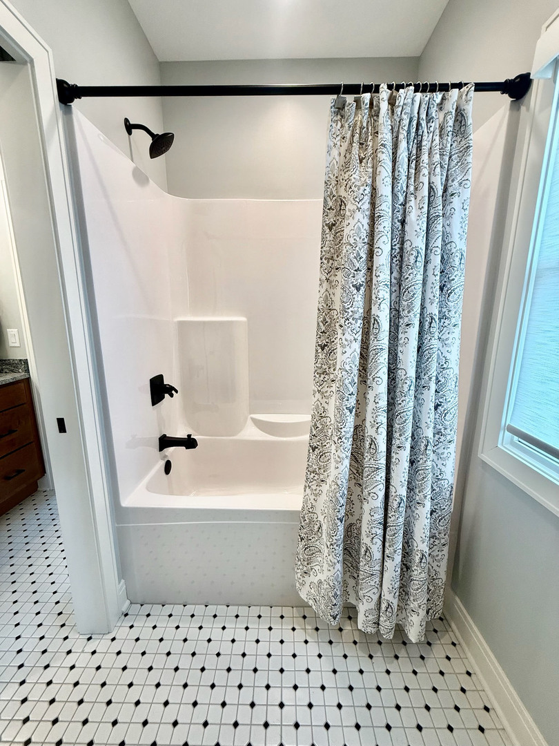 5077 Oak Rdg Court Bettendorf, IA 52722 - Photo 23 of 35 a bathroom with a bathtub and shower