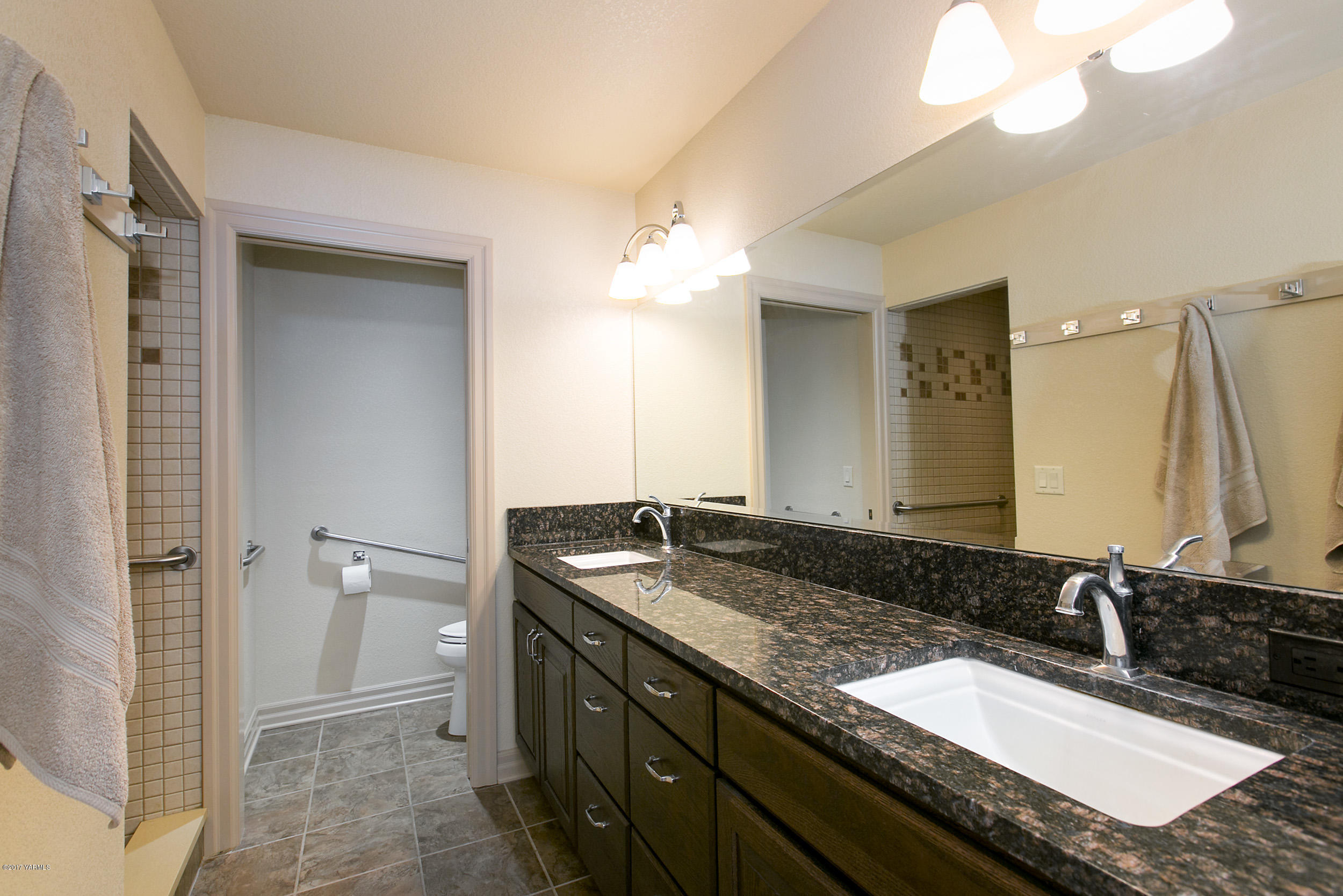 370 Blue Goose Road Zillah, WA 98953 - Photo 11 of 31 a bathroom with a granite countertop sink and a mirror