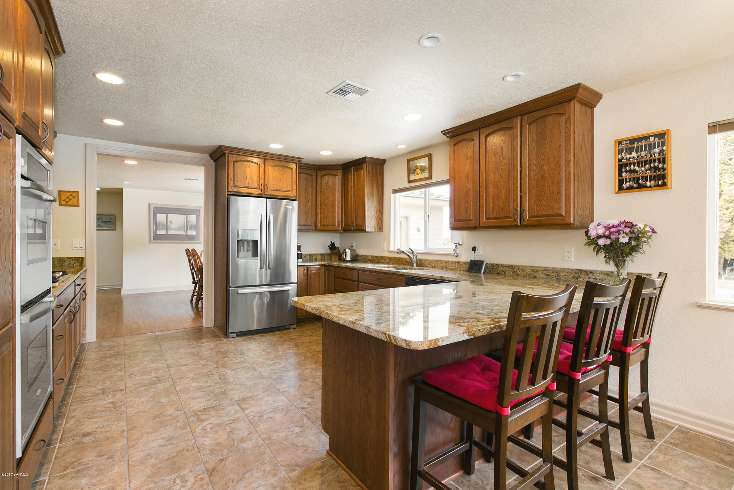 370 Blue Goose Road Zillah, WA 98953 - Photo 5 of 31 a kitchen with stainless steel appliances granite countertop a sink refrigerator and cabinets