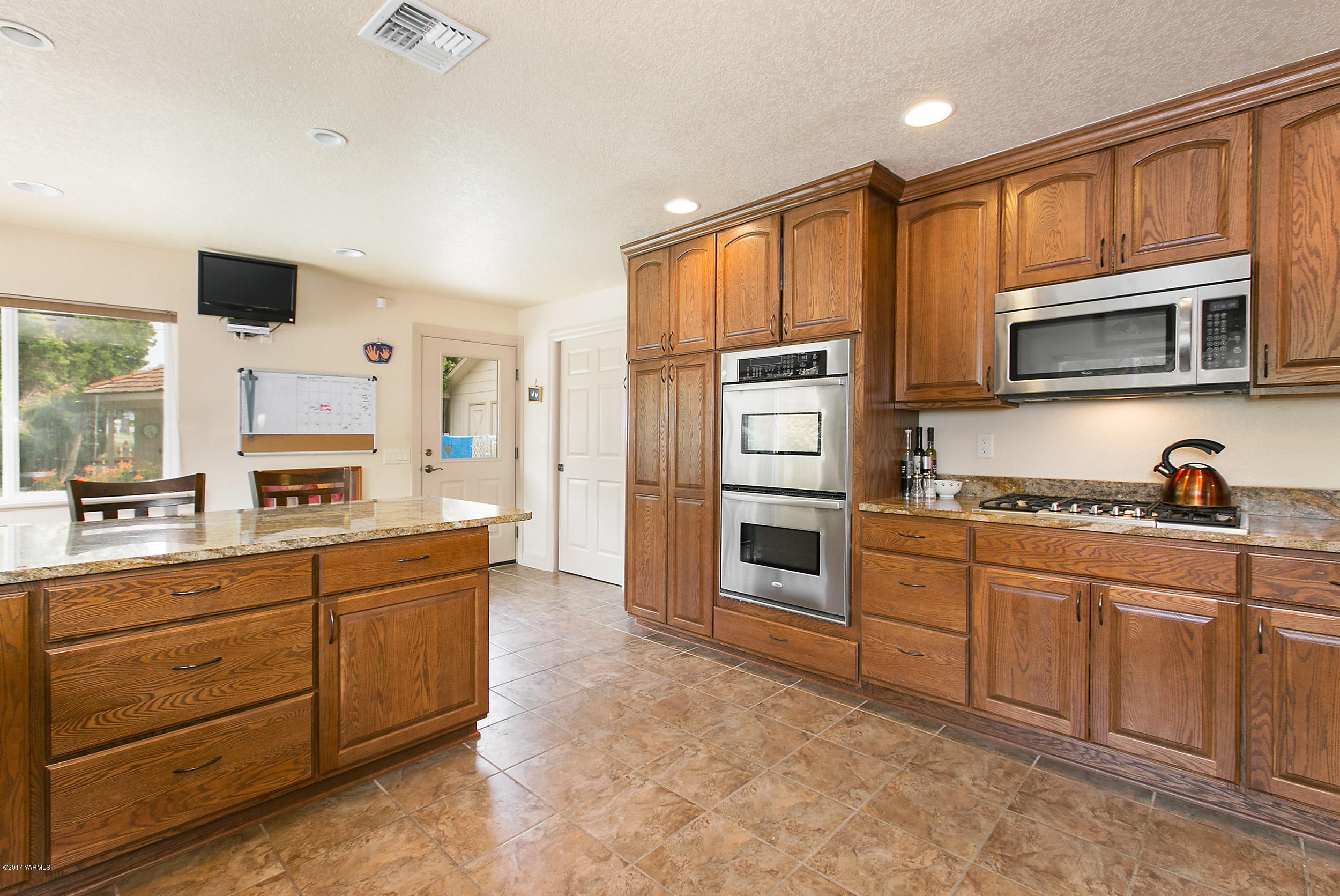370 Blue Goose Road Zillah, WA 98953 - Photo 6 of 31 a kitchen with stainless steel appliances a stove sink and microwave
