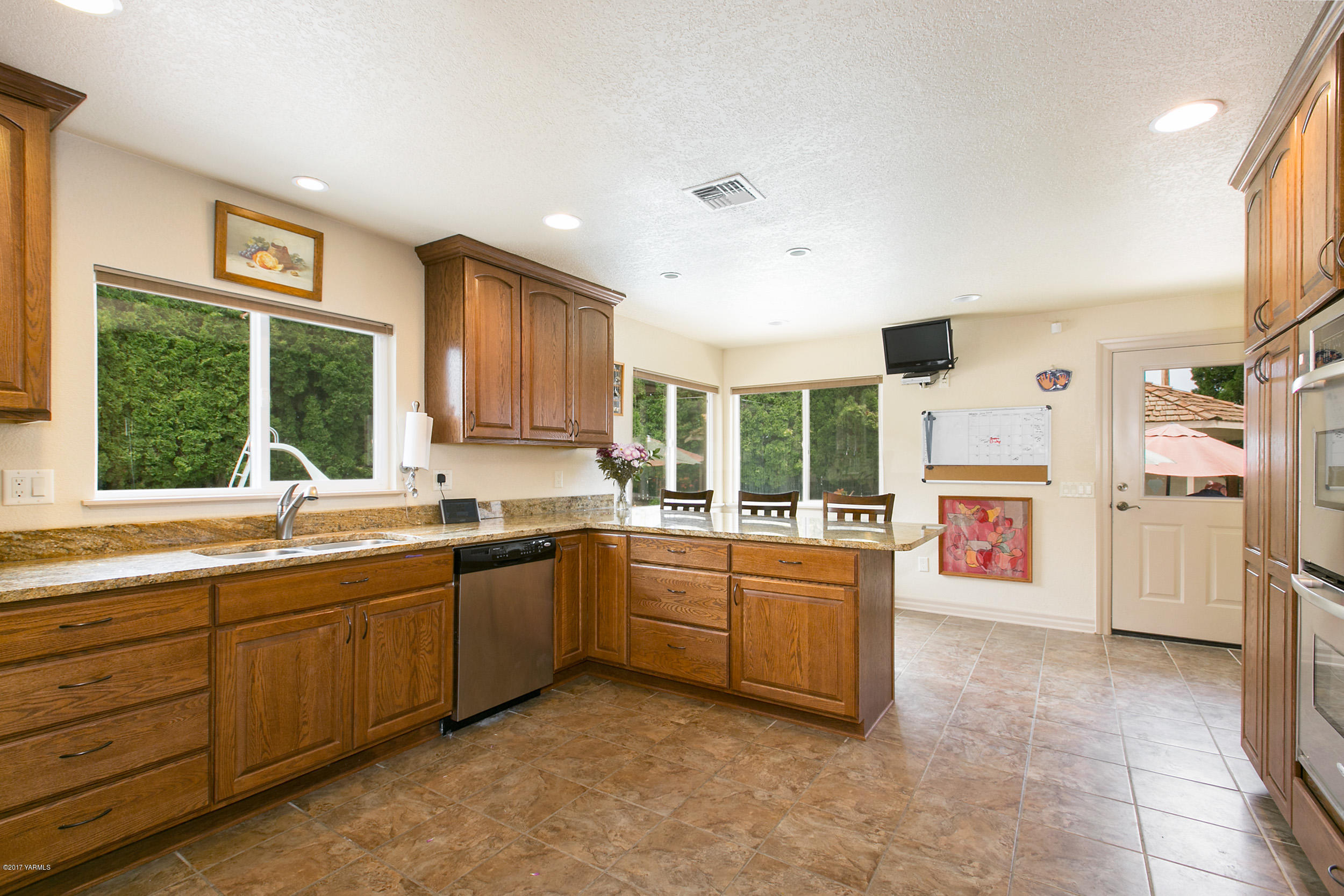 370 Blue Goose Road Zillah, WA 98953 - Photo 7 of 31 a large kitchen with stainless steel appliances granite countertop a refrigerator and a stove top oven