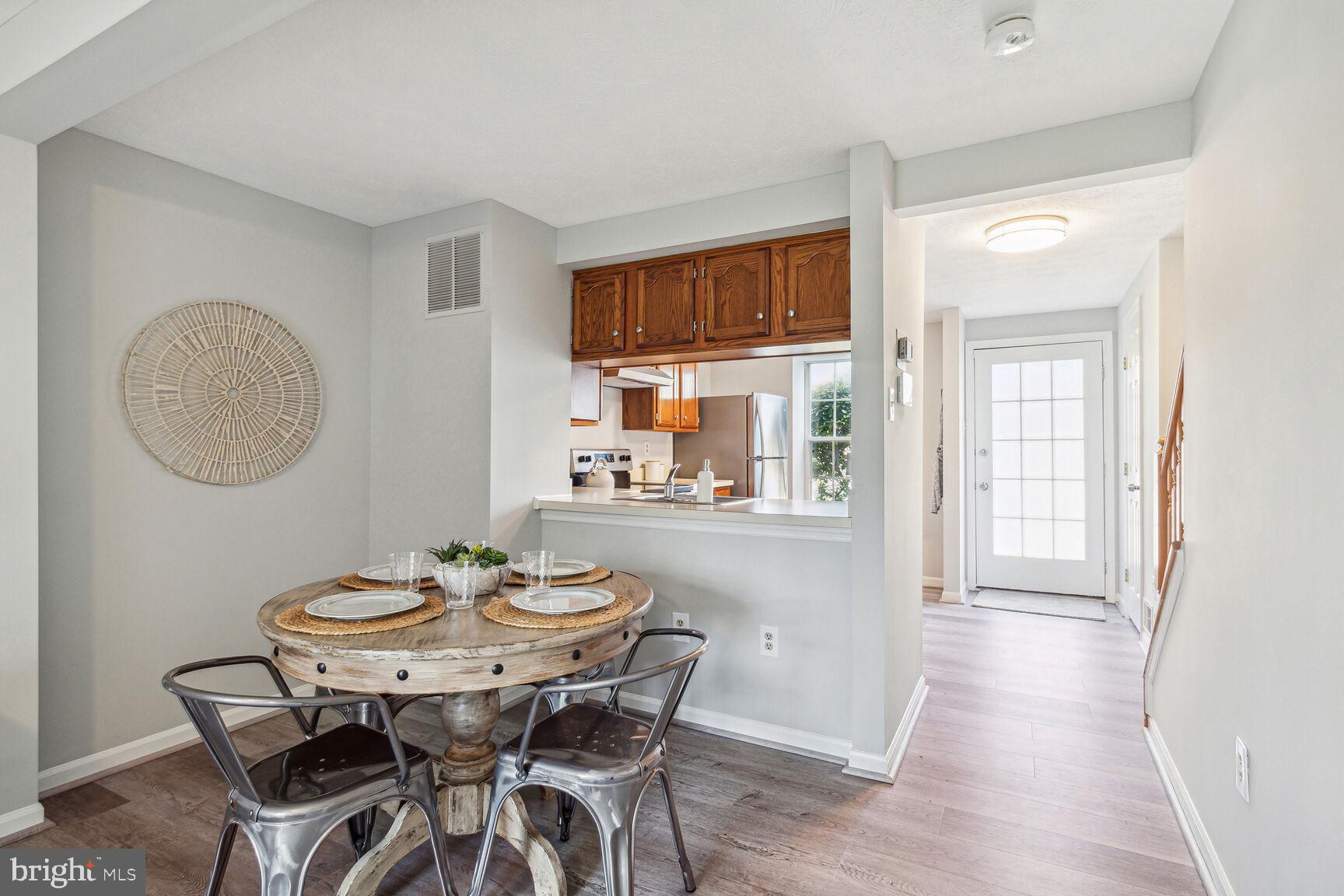 2231 Riding Crop Way Windsor Mill, MD 21244 - Photo 6 of 25 a view of a dining room with furniture window and wooden floor