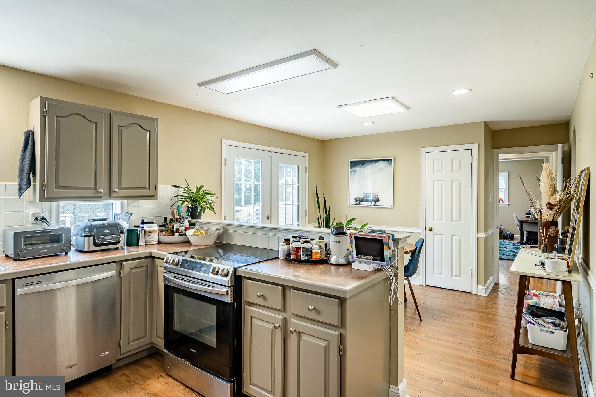 108 Devonwood Lane Devon, PA 19333 - Photo 14 of 55 a kitchen with stainless steel appliances granite countertop a sink stove and cabinets