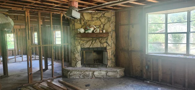 a living room with furniture windows and a fireplace