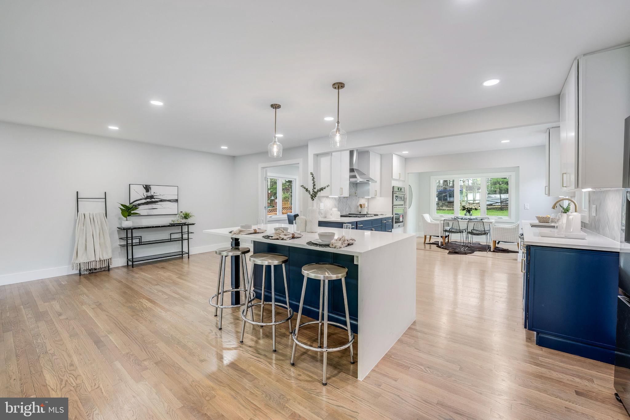a kitchen with stainless steel appliances kitchen island granite countertop a large island in the center