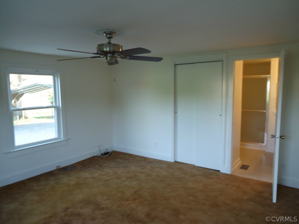 1972 Willow Brook Road Bumpass, VA 23024 - Photo 5 of 18 an empty room with windows and fan