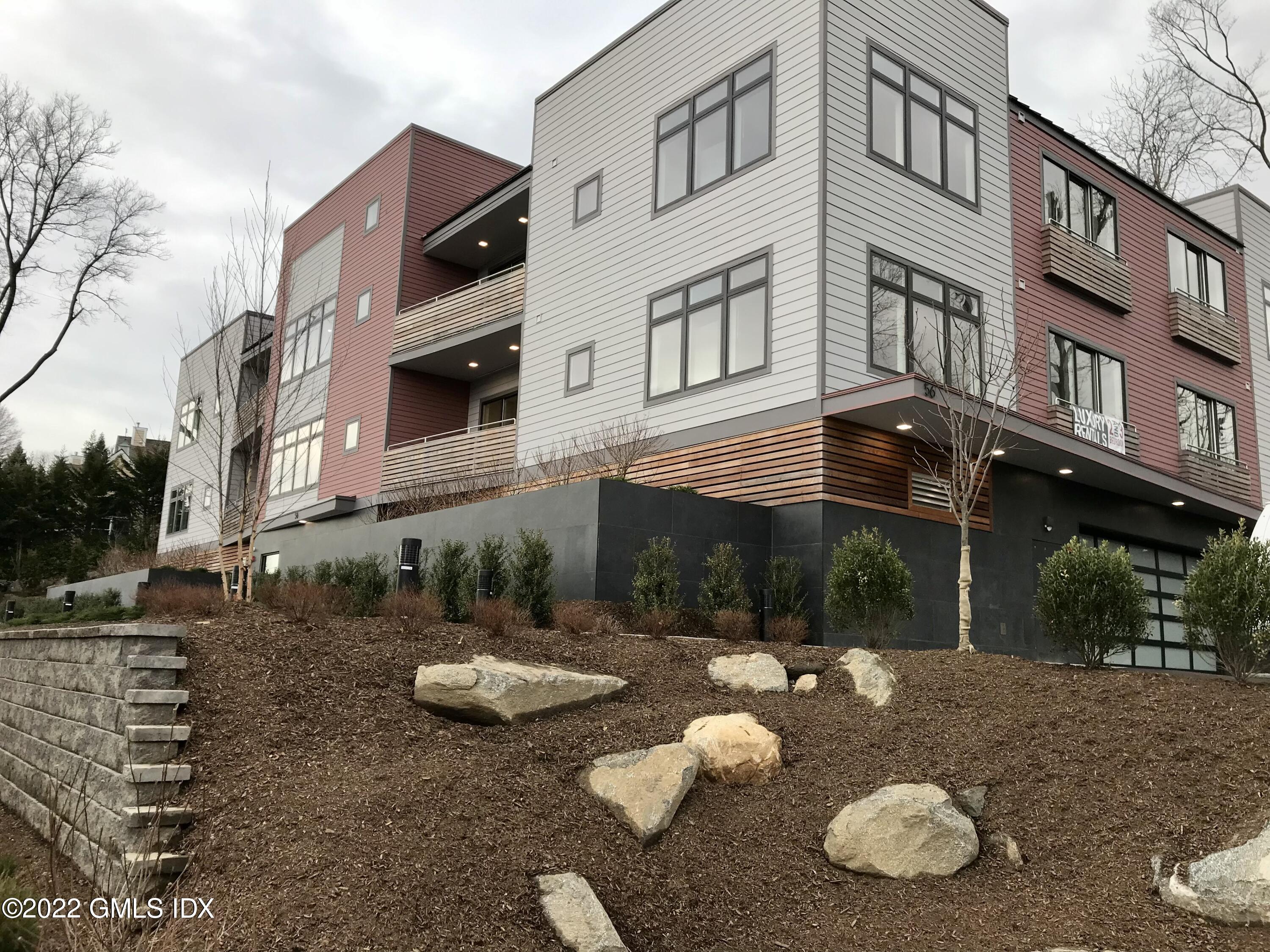a view of a white house with a sink and a table and chairs